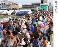 People affected by cyclone Nargis wait to board boats prior to travel back to their devastated villages in Labutta, in the southwest Irrawaddy Delta, Burma, 03 Jun 2008